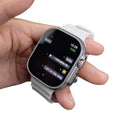 H26 Ultra Smart Watch with transparent frosted silicone band held in hand